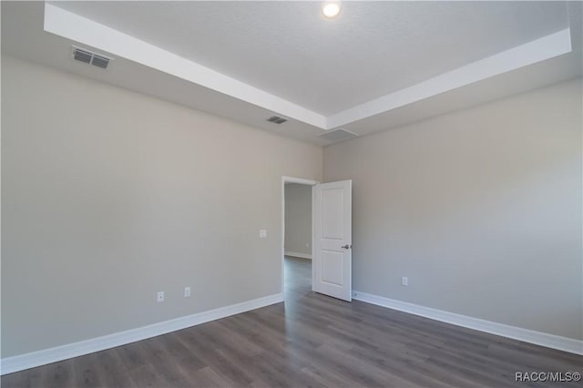 unfurnished room with dark hardwood / wood-style flooring