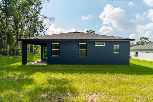 view of property exterior with a yard and a patio