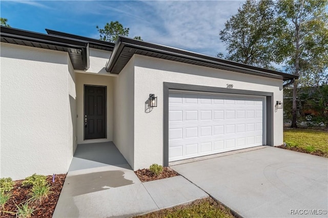 view of exterior entry featuring a garage