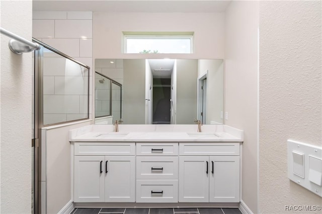 bathroom with vanity and a shower with door