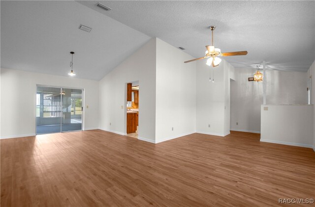 unfurnished living room featuring a textured ceiling, hardwood / wood-style flooring, high vaulted ceiling, and ceiling fan