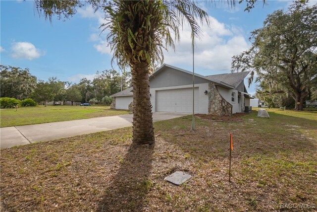 view of front facade with a garage and a front lawn