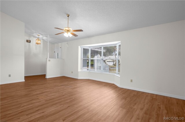 unfurnished living room featuring ceiling fan, a textured ceiling, and hardwood / wood-style flooring