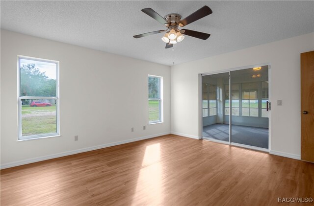 spare room with ceiling fan, hardwood / wood-style floors, and a textured ceiling