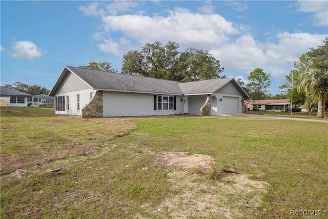 single story home featuring a front yard and a garage