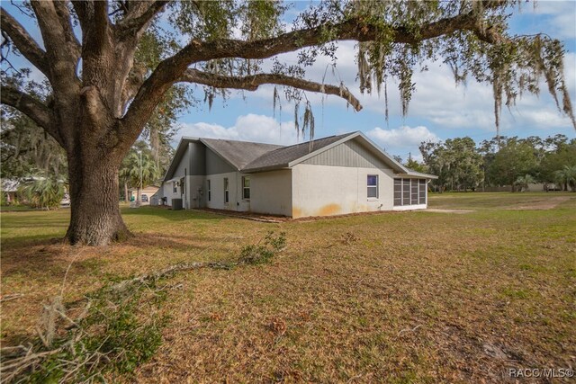 view of side of property with a yard