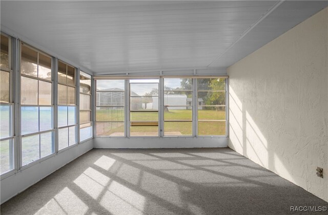 unfurnished sunroom featuring lofted ceiling