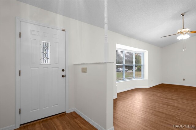 entryway featuring ceiling fan, wood-type flooring, and a textured ceiling