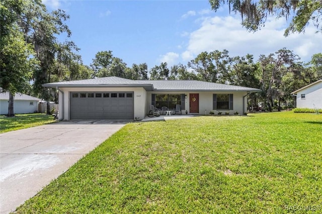 1009 S Maplenut Way, Inverness, FL 34450 - single story home featuring a garage, driveway, a front yard, and stucco siding
