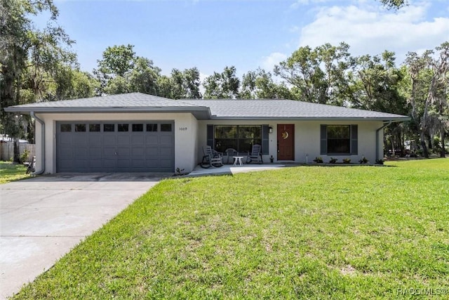 1009 S Maplenut Way, Inverness, FL 34450 - ranch-style house with an attached garage, concrete driveway, a front lawn, stucco siding, and a porch