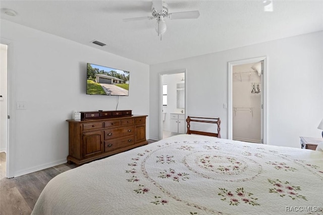 1009 S Maplenut Way, Inverness, FL 34450 - bedroom featuring wood finished floors, connected bathroom, a ceiling fan, a walk in closet, and a closet