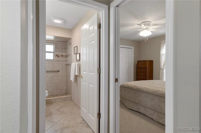 3570 E Cove Park Trl, Hernando, FL 34442 - bathroom with a shower stall, tile patterned floors, toilet, a ceiling fan, and a textured ceiling