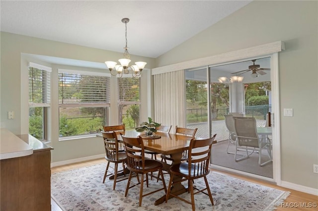 3570 E Cove Park Trl, Hernando, FL 34442 - dining space featuring a chandelier, light wood-style floors, vaulted ceiling, and baseboards