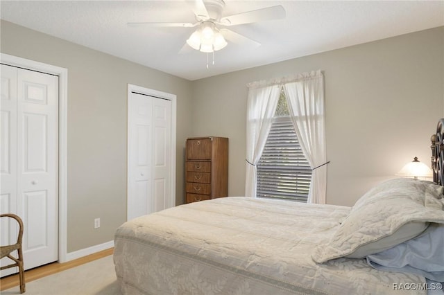 3570 E Cove Park Trl, Hernando, FL 34442 - bedroom featuring multiple closets, wood finished floors, baseboards, and ceiling fan