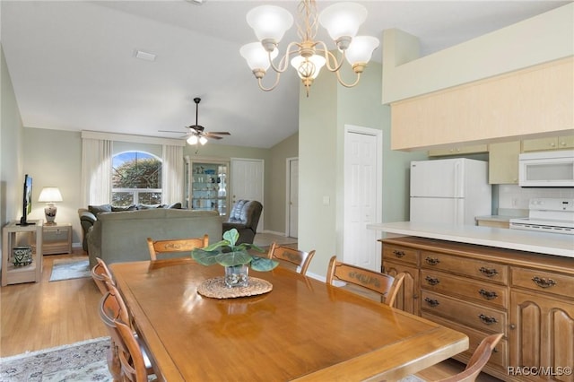 3570 E Cove Park Trl, Hernando, FL 34442 - dining room with vaulted ceiling, ceiling fan, light wood-style flooring, and a chandelier