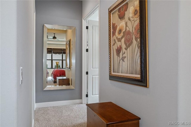 hallway with carpet and baseboards