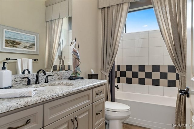 full bathroom with vanity, shower / bath combo, and toilet