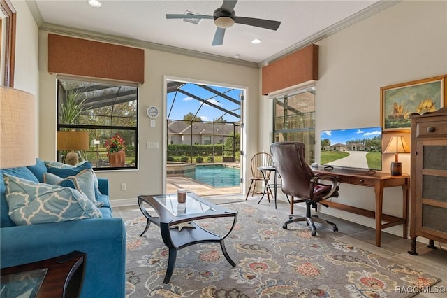 interior space featuring ceiling fan, plenty of natural light, and crown molding