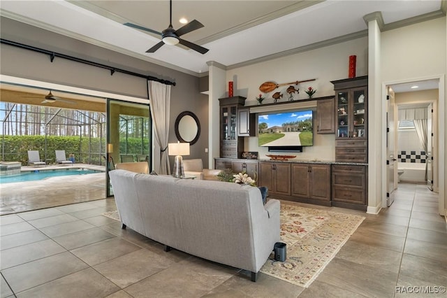 living room with light tile patterned floors and ornamental molding