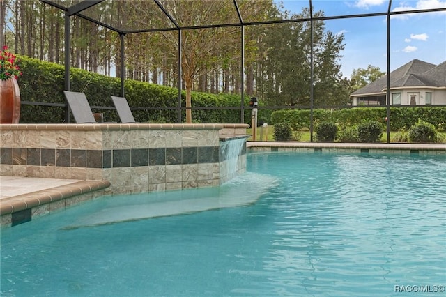 view of swimming pool with glass enclosure