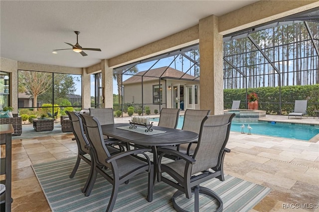 sunroom / solarium with ceiling fan and a swimming pool