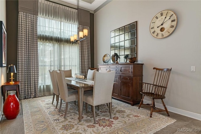 dining area featuring crown molding and a chandelier