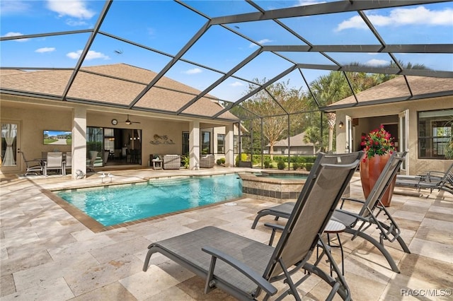 view of pool featuring an in ground hot tub, glass enclosure, ceiling fan, and a patio area