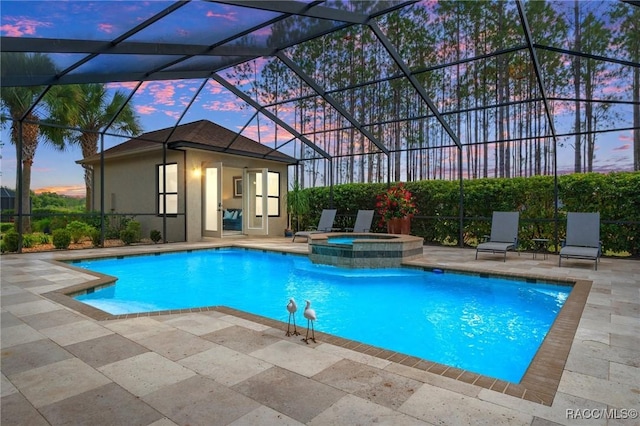 view of swimming pool with an outdoor structure, a patio area, a lanai, and a pool with connected hot tub