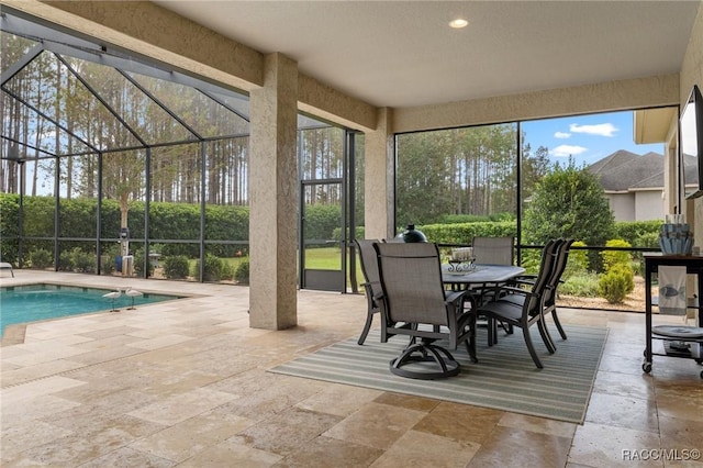 sunroom featuring a swimming pool