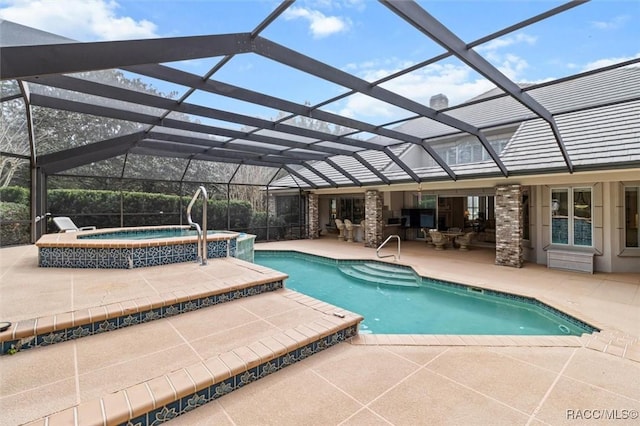 view of pool featuring a patio, a lanai, and a pool with connected hot tub