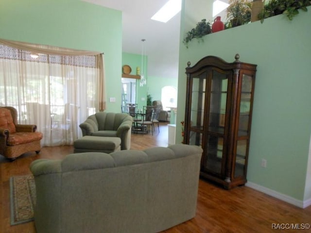 141 W Forest Oak Pl, Beverly Hills, FL 34465 - living room with a towering ceiling, baseboards, and wood finished floors