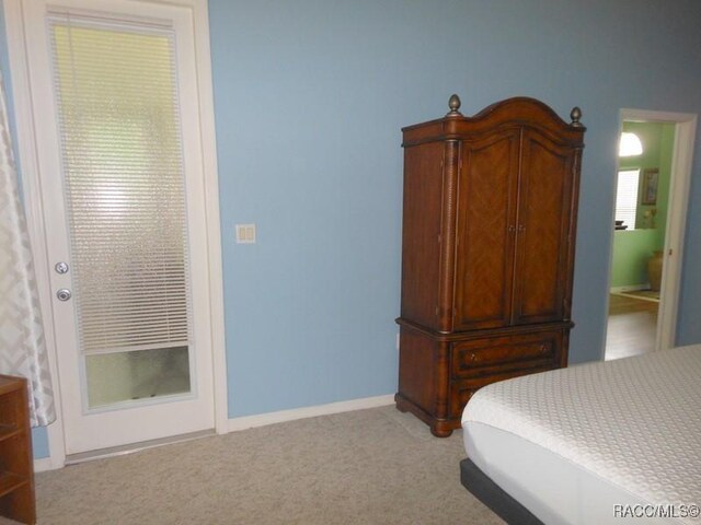 141 W Forest Oak Pl, Beverly Hills, FL 34465 - carpeted bedroom featuring baseboards and ensuite bath