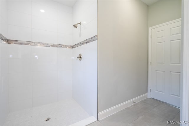 bathroom featuring a tile shower and tile patterned floors