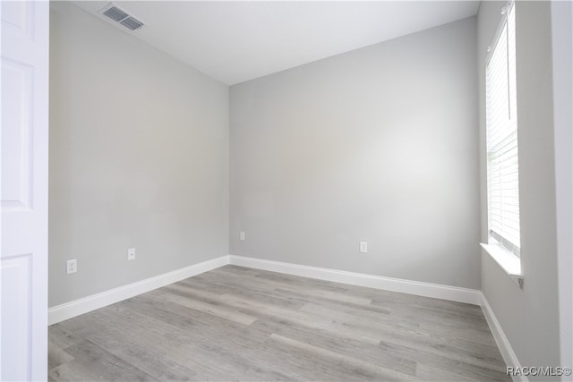 spare room featuring light hardwood / wood-style floors