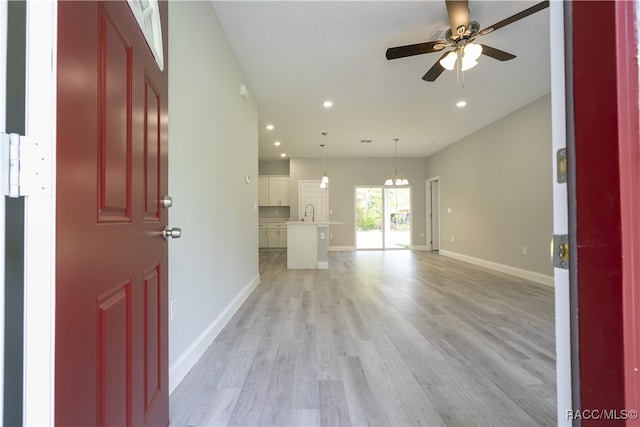 interior space featuring ceiling fan, sink, and light hardwood / wood-style flooring