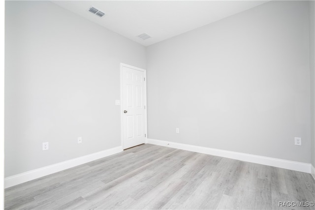 spare room featuring light hardwood / wood-style flooring