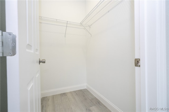 spacious closet with light hardwood / wood-style floors