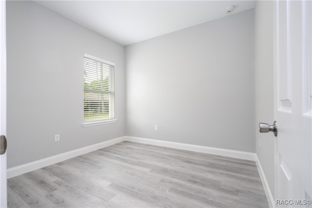 unfurnished room with light wood-type flooring