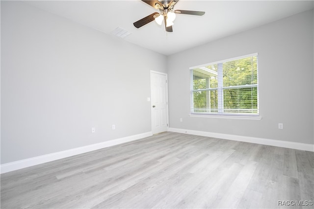 spare room featuring light wood-type flooring and ceiling fan