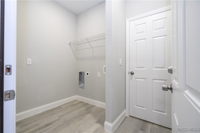 laundry room with hookup for an electric dryer and light wood-type flooring