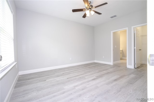 empty room with ceiling fan and light wood-type flooring