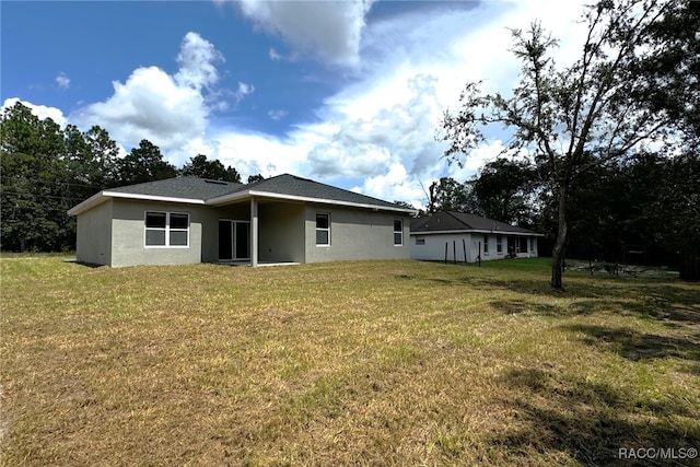 rear view of house with a yard