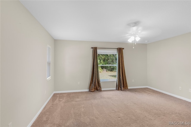 unfurnished room with light carpet and ceiling fan