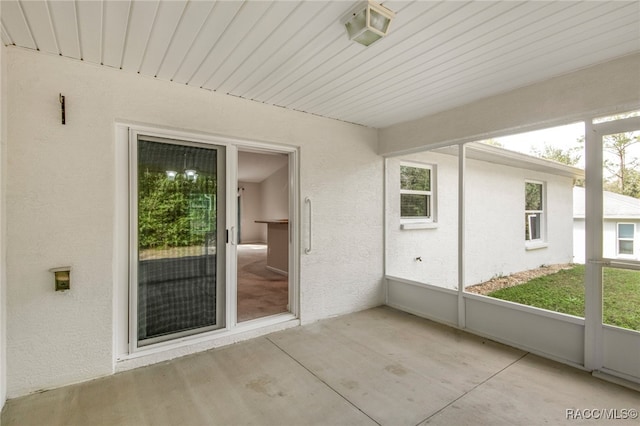 unfurnished sunroom with wood ceiling