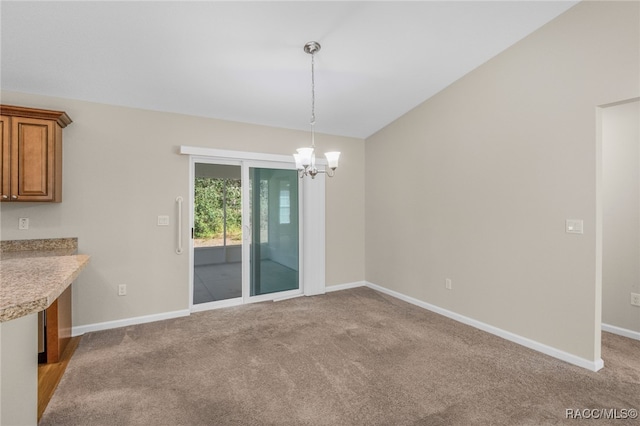 unfurnished dining area with light carpet, vaulted ceiling, and a notable chandelier