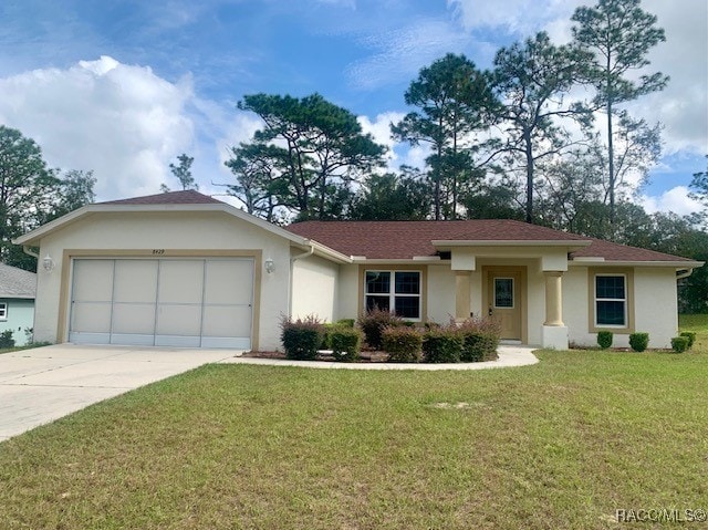 view of front of home featuring a garage and a front lawn