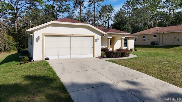 single story home with a garage and a front lawn