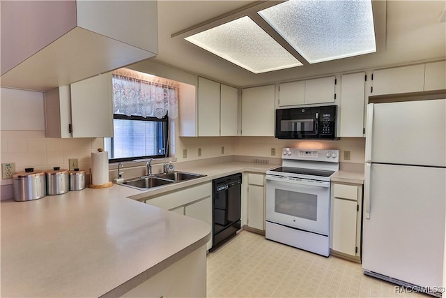 5618 W Hesse Ct, Homosassa, FL 34448 - kitchen with tasteful backsplash, light floors, light countertops, black appliances, and a sink