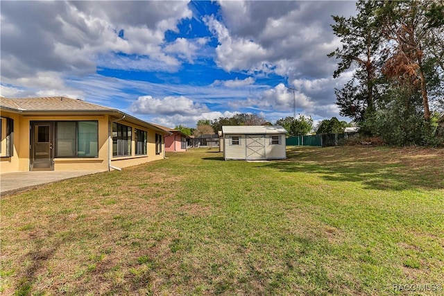 5618 W Hesse Ct, Homosassa, FL 34448 - view of yard featuring a patio area, a shed, and an outbuilding