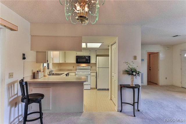 5618 W Hesse Ct, Homosassa, FL 34448 - kitchen featuring white appliances, light carpet, a peninsula, and a kitchen breakfast bar